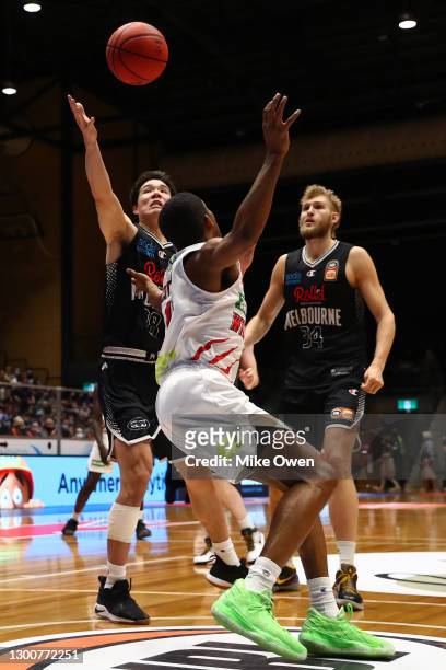 Yudai Baba of United and Bryce Cotton of the Wildcats compete for the ball during the round four NBL match between Melbourne United and the Perth...