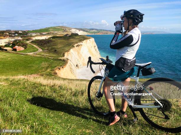 woman cyclist photographer, isle of wight - isle of wight stock pictures, royalty-free photos & images