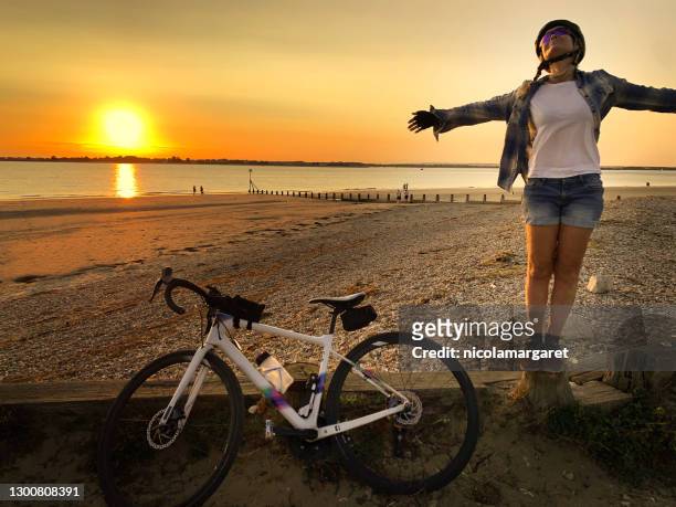woman cyclist enjoying freedom - portsmouth england stock pictures, royalty-free photos & images