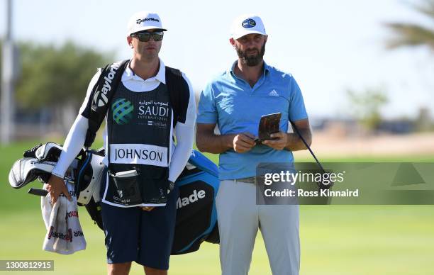 Dustin Johnson of the USA and caddy Austin Johnson on the 18th green during Day Four of the Saudi International powered by SoftBank Investment...