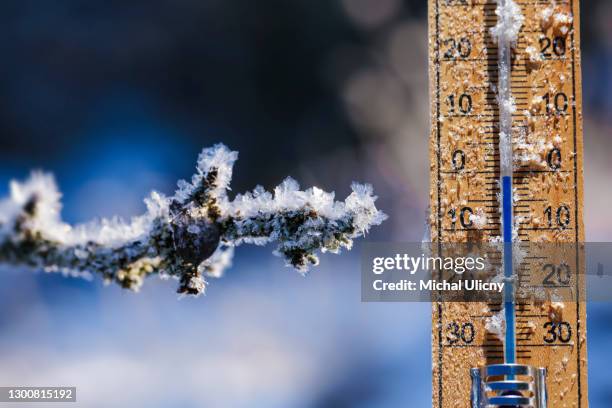 thermometer in winter, which shows the freezing point. temperature measured in degrees celsius . - meteorology thermometers stock pictures, royalty-free photos & images