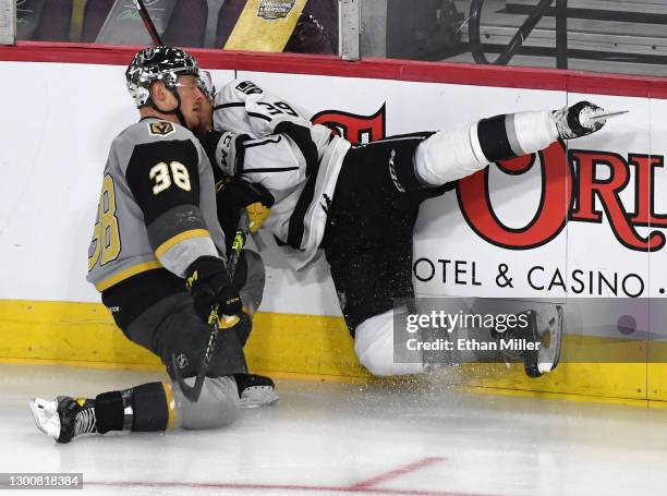 Patrick Brown of the Henderson Silver Knights checks Alex Turcotte of the Ontario Reign into the boards in the first period of the Silver Knights'...