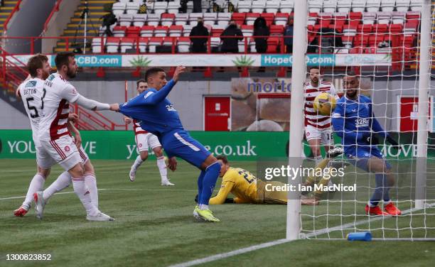 Brian Easton of Hamilton Academical scores an own which is Rangers first goal as James Tavernier of Rangers has his shirt pulled by Scott McMann of...