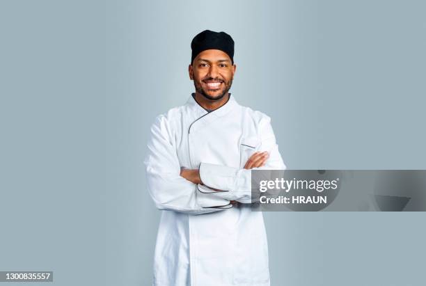 smiling male cook on gray background - black chef stock pictures, royalty-free photos & images