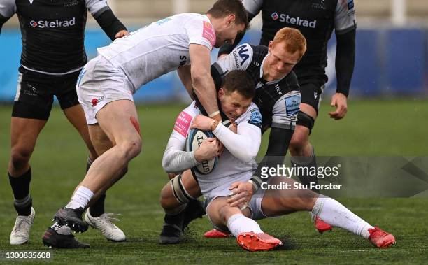 Chiefs fly half Joe Simmonds is wrapped up by Falcons number 8 Philip van der Walt during the Gallagher Premiership Rugby match between Newcastle...