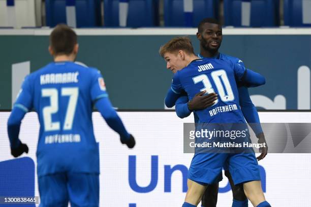 Ihlas Bebou of TSG 1899 Hoffenheim celebrates with team mate Marco John after scoring their side's first goal during the Bundesliga match between TSG...