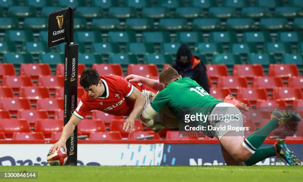 Louis Rees-Zammit of Wales touches down to score their side's second try as Tadhg Furlong of Ireland attempts to tackle during the Guinness Six...