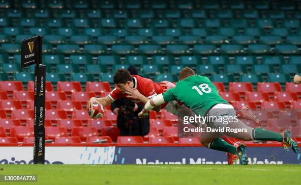 Louis Rees-Zammit of Wales touches down to score their side's second try as Tadhg Furlong of Ireland attempts to tackle during the Guinness Six...