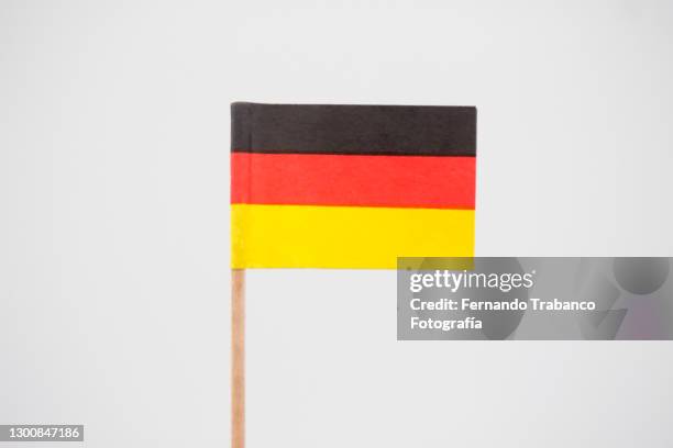 german flag on white background - small german flag stock pictures, royalty-free photos & images