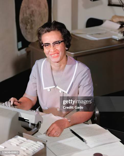 Portrait of NASA human computer and African-American mathematical pioneer Katherine Johnson smiling, at a desk with notes, 1966. Image courtesy NASA....