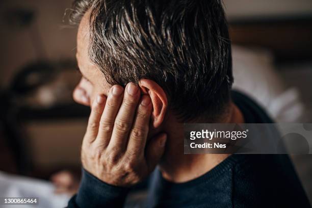 ear pain, older man - listening imagens e fotografias de stock