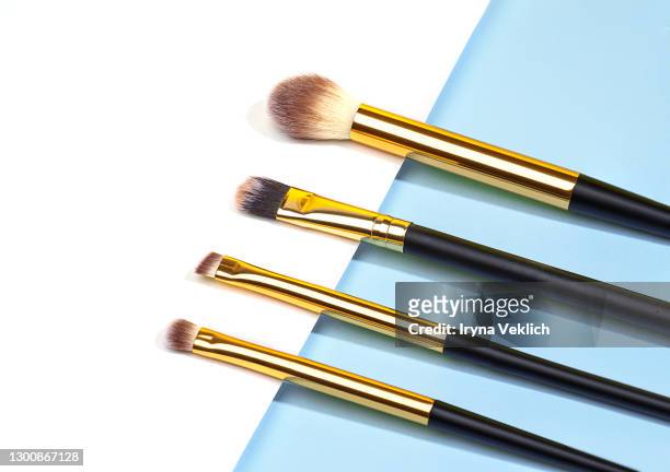 set of different makeup brushes, makeup tools on pastel blue and white background. - sminkborste bildbanksfoton och bilder