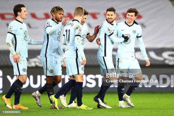 Jorginho of Chelsea celebrates with Mason Mount, Reece James and team mates after scoring their side's second goal from the penalty spot during the...