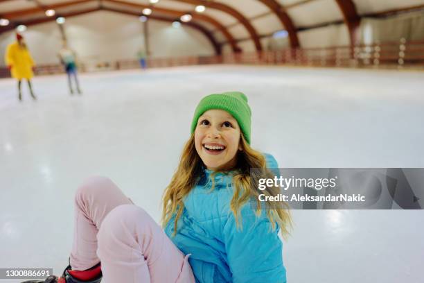 girl learning how to ice-skate - indoor ice skating stock pictures, royalty-free photos & images