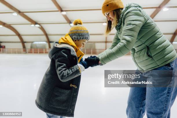 learning how to ice-skate with my mom - learning to ice skate stock pictures, royalty-free photos & images