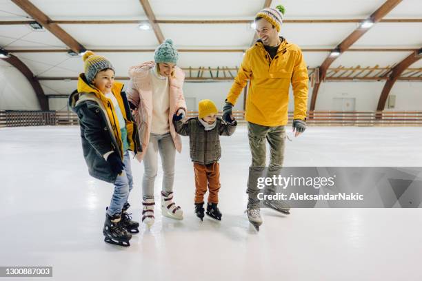 family ice-skating - winter woman showing stock pictures, royalty-free photos & images