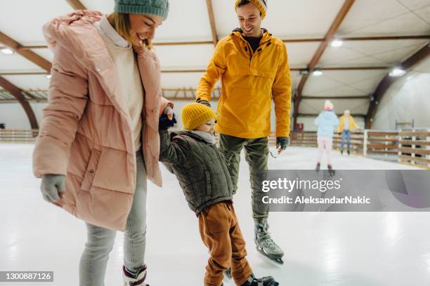 little boy learning how to ice-skate - learning to ice skate stock pictures, royalty-free photos & images