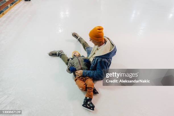 funny accident on the ice-skating rink - family ice skate stock pictures, royalty-free photos & images