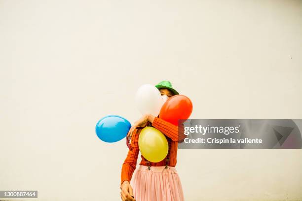 woman with colorful balloons and protective mask at carnival - la fete stockfoto's en -beelden