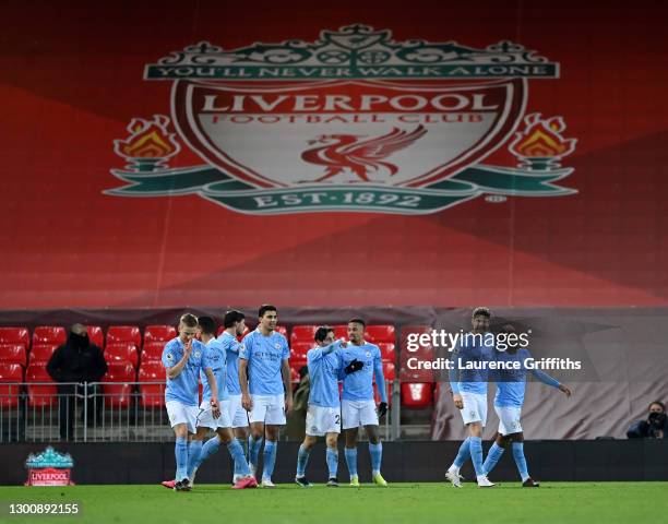 Raheem Sterling of Manchester City is congratulated by John Stones after scoring their side's third goal during the Premier League match between...