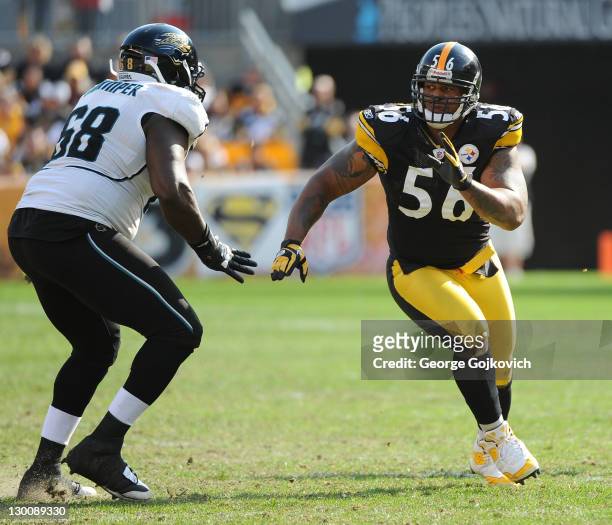 Linebacker LaMarr Woodley of the Pittsburgh Steelers pursues the play against offensive lineman Guy Whimper of the Jacksonville Jaguars during a game...