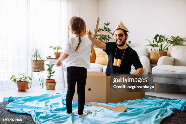 father playing exciting adventure game with daughter - fancy dress costume stock pictures, royalty-free photos & images