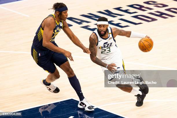 Royce O'Neale of the Utah Jazz dribbles down the court past Myles Turner of the Indiana Pacers at Bankers Life Fieldhouse on February 7, 2021 in...