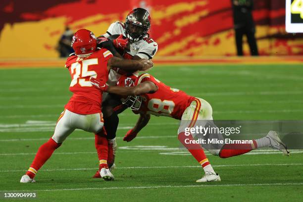 Charvarius Ward of the Kansas City Chiefs and L'Jarius Sneed tackle Ronald Jones of the Tampa Bay Buccaneers in the second quarter in Super Bowl LV...