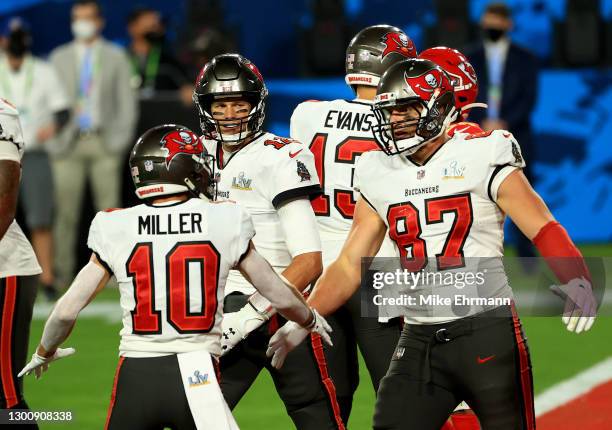 Rob Gronkowski of the Tampa Bay Buccaneers reacts after scoring a 17 yard touchdown with Tom Brady and Scott Miller in the second quarter against the...