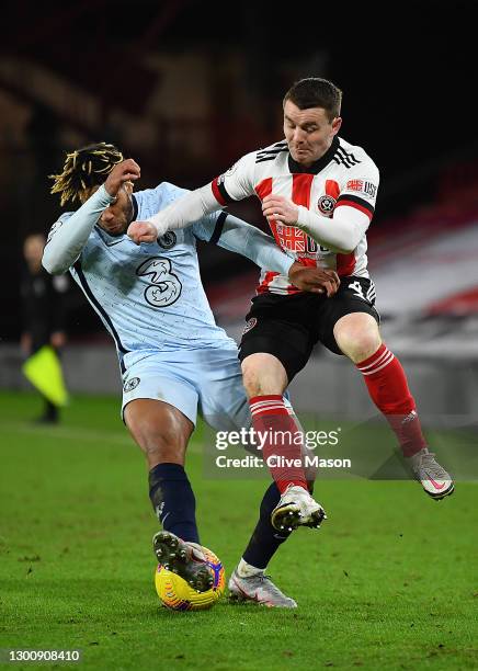 Reece James of Chelsea is tackled by John Fleck of Sheffield United during the Premier League match between Sheffield United and Chelsea at Bramall...