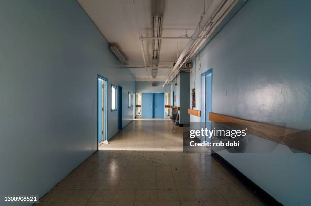 blue hallway inside abandoned asylum - psychiatric hospital stock pictures, royalty-free photos & images