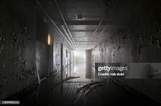 decaying flooded tunnel inside abandoned asylum - flooded room stock pictures, royalty-free photos & images