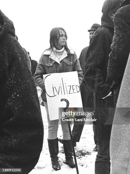 Protestor holding sign during an anti-war demonstration in Detroit, Michigan, in 1965.