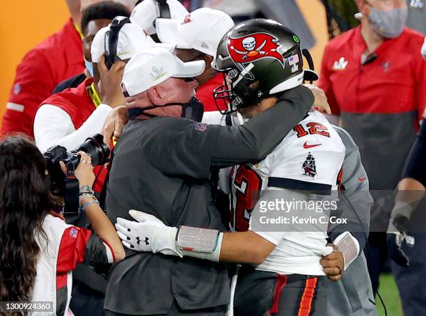 Tom Brady of the Tampa Bay Buccaneers celebrates with head coach Bruce Arians after defeating the Kansas City Chiefs in Super Bowl LV at Raymond...