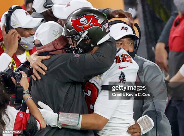 Tom Brady of the Tampa Bay Buccaneers celebrates with head coach Bruce Arians after defeating the Kansas City Chiefs in Super Bowl LV at Raymond...