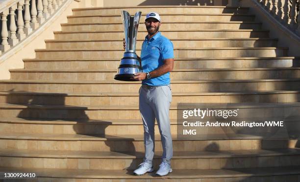 Dustin Johnson of the USA poses with the trophy after winning the Saudi International powered by SoftBank Investment Advisers at Royal Greens Golf...