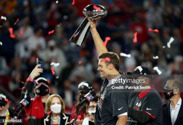 Tom Brady of the Tampa Bay Buccaneers celebrates with the Lombardi Trophy after defeating the Kansas City Chiefs in Super Bowl LV at Raymond James...