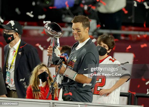 Tom Brady of the Tampa Bay Buccaneers celebrates with the Lombardi Trophy after defeating the Kansas City Chiefs in Super Bowl LV at Raymond James...