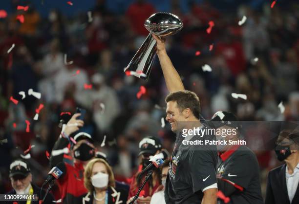 Tom Brady of the Tampa Bay Buccaneers celebrates with the Lombardi Trophy after defeating the Kansas City Chiefs in Super Bowl LV at Raymond James...