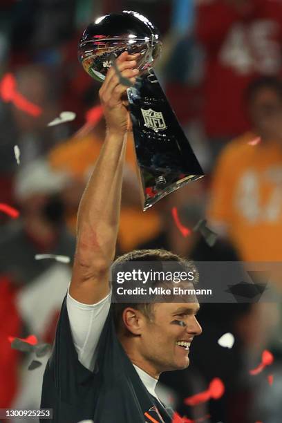 Tom Brady of the Tampa Bay Buccaneers celebrates with the Lombardi Trophy after defeating the Kansas City Chiefs in Super Bowl LV at Raymond James...