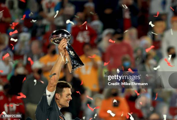 Tom Brady of the Tampa Bay Buccaneers celebrates with the Lombardi Trophy after defeating the Kansas City Chiefs in Super Bowl LV at Raymond James...