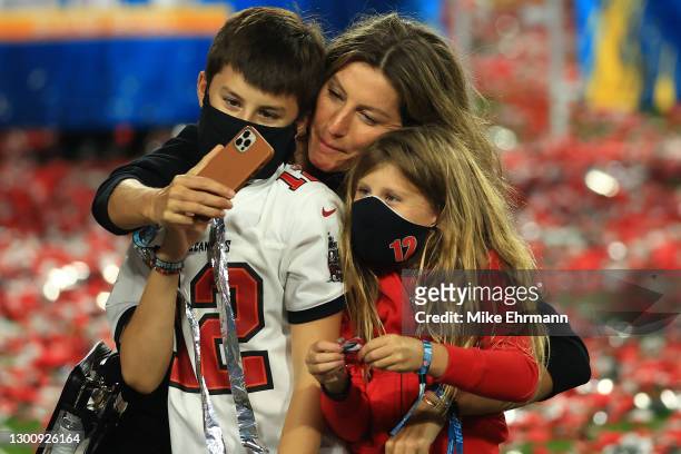 Gisele Bundchen celebrates with Vivian Brady and Benjamin Brady after the Buccaneers defeated the Kansas City Chiefs in Super Bowl LV at Raymond...