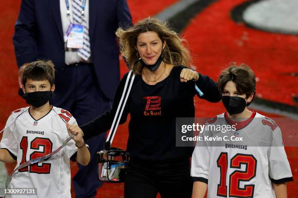 Gisele Bundchen, wife of Tom Brady of the Tampa Bay Buccaneers, celebrates with Benjamin Brady and John Moynahan after the Buccaneers defeated the...