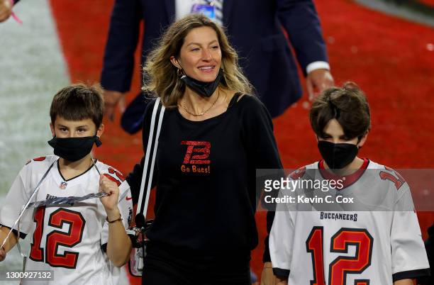 Gisele Bundchen, wife of Tom Brady of the Tampa Bay Buccaneers, celebrates with Benjamin Brady and John Moynahan after the Buccaneers defeated the...