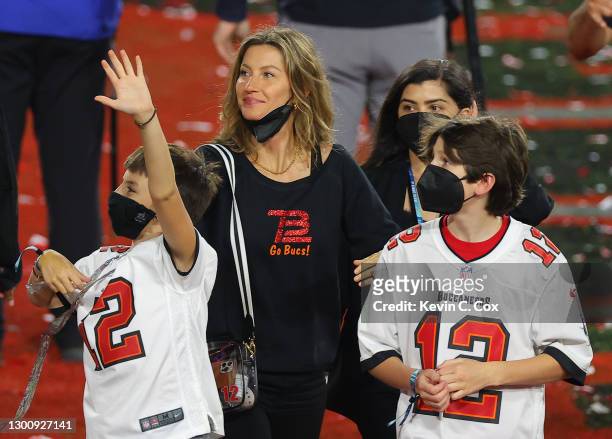 Gisele Bundchen, wife of Tom Brady of the Tampa Bay Buccaneers, celebrates with Benjamin Brady and John Moynahan after the Buccaneers defeated the...