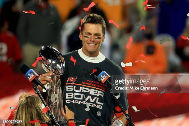 Tom Brady of the Tampa Bay Buccaneers hoists the Vince Lombardi Trophy after winning Super Bowl LV at Raymond James Stadium on February 07, 2021 in...