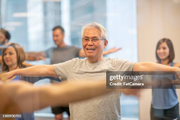 exercising keeps me young and healthy - warm up exercise indoor stock pictures, royalty-free photos & images