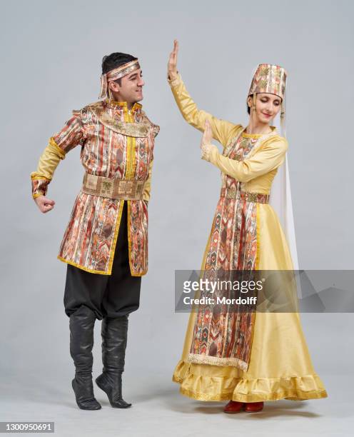 two dancers (male and female) in armenian national clothes are showing pose of traditional dance - beautiful armenian women stock pictures, royalty-free photos & images