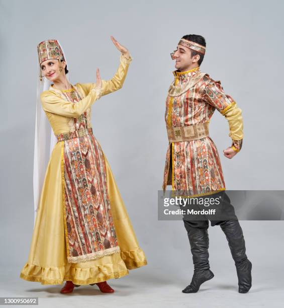 two dancers (male and female) in armenian national clothes are dancing traditional dance - beautiful armenian women stock pictures, royalty-free photos & images