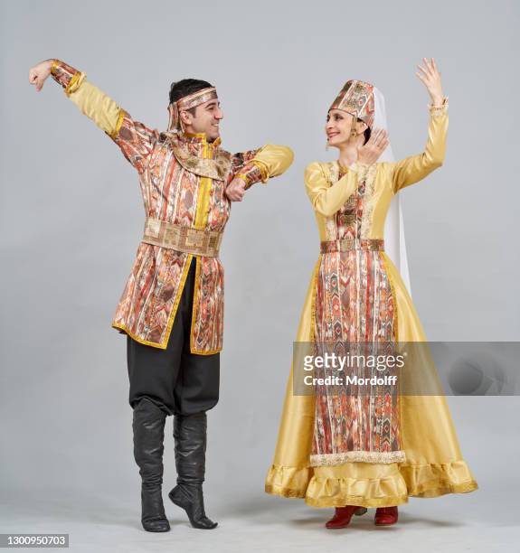 two dancers (male and female) in armenian folk clothes are performing traditional dance - beautiful armenian women stock pictures, royalty-free photos & images